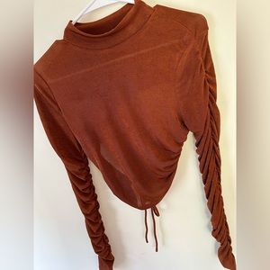 Orange sheer top. Slim fit, but stretchy. Open back with tie. Size large